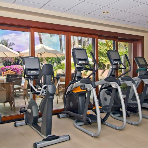 A gym scene with several cardio machines and people exercising. Always end with a period, up to 140 characters.